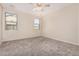 Light-filled, carpeted bedroom with neutral walls and two windows allowing natural light at 2530 W Gaby Rd, Phoenix, AZ 85041