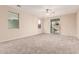 A carpeted, empty bedroom with neutral walls and two windows offering plenty of natural light at 2530 W Gaby Rd, Phoenix, AZ 85041