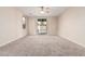 An empty bedroom featuring new carpet and a sliding glass door leading to a patio at 2530 W Gaby Rd, Phoenix, AZ 85041