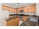 Open kitchen featuring stainless steel appliances, an island, and a large sink with granite countertops at 2530 W Gaby Rd, Phoenix, AZ 85041