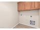 The laundry room features overhead cabinets and new flooring at 2530 W Gaby Rd, Phoenix, AZ 85041