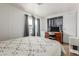 Bedroom featuring a desk, workstation, and comfortable bed covered with a decorative quilt at 2650 W Union Hills Dr # 329, Phoenix, AZ 85027