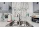 Close-up of the kitchen sink area featuring updated fixtures and a bright, clean design at 2650 W Union Hills Dr # 329, Phoenix, AZ 85027