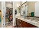 Granite vanity top with dual sinks and a floral shower curtain add charm to this bathroom at 3110 E Cat Balue Dr, Phoenix, AZ 85050