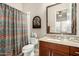 Well-maintained bathroom with granite counters, patterned shower curtain and decor at 3110 E Cat Balue Dr, Phoenix, AZ 85050