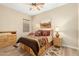 Comfortable bedroom featuring a ceiling fan, warm paint, and carpet with a southwest pattern at 3110 E Cat Balue Dr, Phoenix, AZ 85050