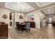 Beautiful dining room with wood floors, a modern light fixture, and a built in wine fridge at 3110 E Cat Balue Dr, Phoenix, AZ 85050