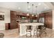 Gourmet kitchen featuring a large island with counter seating, stainless steel appliances, and custom cabinetry at 3110 E Cat Balue Dr, Phoenix, AZ 85050