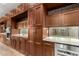 This kitchen features custom cabinetry and granite countertops and stainless steel appliances at 3110 E Cat Balue Dr, Phoenix, AZ 85050