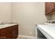 Spacious laundry area with granite countertop, stainless steel sink, and updated washer/dryer at 3110 E Cat Balue Dr, Phoenix, AZ 85050