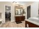 Spacious main bathroom with dual sinks and access to walk-in closet at 3110 E Cat Balue Dr, Phoenix, AZ 85050