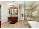 Well-lit main bathroom with a large glass walk-in shower and a makeup vanity at 3110 E Cat Balue Dr, Phoenix, AZ 85050