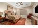 Serene main bedroom with a tray ceiling, large window, and comfortable furnishings at 3110 E Cat Balue Dr, Phoenix, AZ 85050