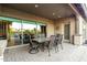 Covered patio with dining table and chairs, perfect for outdoor entertaining at 3110 E Cat Balue Dr, Phoenix, AZ 85050