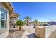 Expansive backyard featuring a covered patio, built-in grill, and beautiful landscaping, perfect for outdoor living at 32241 N Dog Leg Ct, San Tan Valley, AZ 85143