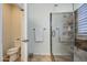 Bathroom with a glass enclosed shower, granite tile detail, and toilet separated in its own room at 32241 N Dog Leg Ct, San Tan Valley, AZ 85143