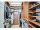 Walk-in closet with custom shelving and racks for ample storage of clothing and shoes at 32241 N Dog Leg Ct, San Tan Valley, AZ 85143