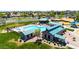 Aerial view of the neighborhood community pool and amenity center with ample green space at 32241 N Dog Leg Ct, San Tan Valley, AZ 85143