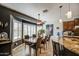 Modern dining area featuring tile floors, large windows, and a view into the kitchen at 32241 N Dog Leg Ct, San Tan Valley, AZ 85143