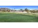 Scenic golf course community featuring lush green lawns and beautiful desert landscaping at 32241 N Dog Leg Ct, San Tan Valley, AZ 85143