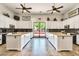 Modern kitchen featuring white cabinetry, granite countertops, and stainless steel appliances at 32241 N Dog Leg Ct, San Tan Valley, AZ 85143