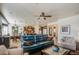 Bright living room with tile floors, ceiling fan, and an open view to the dining area and kitchen at 32241 N Dog Leg Ct, San Tan Valley, AZ 85143