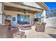 Covered patio with comfortable seating, a built-in bar, and views of the serene backyard, perfect for entertaining at 32241 N Dog Leg Ct, San Tan Valley, AZ 85143