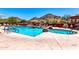 Inviting community pool and spa area with mountain views and lounge seating, perfect for relaxing and enjoying the outdoors at 32241 N Dog Leg Ct, San Tan Valley, AZ 85143