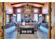 Inviting reading room with stone fireplace, beamed ceiling, leather sofas and a library of books at 32241 N Dog Leg Ct, San Tan Valley, AZ 85143