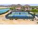 Aerial view of well maintained community tennis courts surrounded by lush landscaping and desert scenery at 32241 N Dog Leg Ct, San Tan Valley, AZ 85143