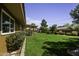 Lush backyard featuring a well-manicured lawn, mature trees, and manicured landscaping at 325 E Aepli Dr, Tempe, AZ 85282