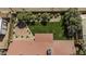 Aerial view of a backyard featuring a manicured lawn, mature trees and landscaping, and a brick patio area at 325 E Aepli Dr, Tempe, AZ 85282