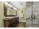 Bathroom features an oversized wood framed mirror above dual vanities and a glass enclosed shower at 325 E Aepli Dr, Tempe, AZ 85282