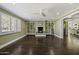 Spacious living room with built-in shelving, a fireplace, and hardwood floors at 325 E Aepli Dr, Tempe, AZ 85282