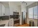 Kitchen featuring stainless appliances, white cabinets, and modern backsplash at 3302 N 7Th St # 364, Phoenix, AZ 85014