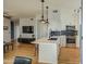 Open-concept kitchen with modern appliances, white cabinets, and a breakfast bar at 3302 N 7Th St # 364, Phoenix, AZ 85014