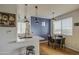 Bright eat-in kitchen featuring a breakfast bar, modern pendant lights, and an accent wall at 3302 N 7Th St # 364, Phoenix, AZ 85014