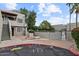 Two-story condo with lush landscaping, including trees and bushes, and exterior electrical boxes and connections at 3309 N 70Th St # 108, Scottsdale, AZ 85251