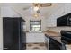 Bright kitchen with white cabinets, black appliances, laminate countertops, and a ceiling fan at 3309 N 70Th St # 108, Scottsdale, AZ 85251