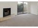 Bright living room with fireplace, sliding glass doors, neutral carpet, and white walls at 3309 N 70Th St # 108, Scottsdale, AZ 85251