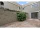 Private tiled patio surrounded by textured walls and greenery at 3309 N 70Th St # 108, Scottsdale, AZ 85251