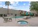 Community pool and hot tub with lounge chairs, umbrellas, and manicured landscaping at 3309 N 70Th St # 108, Scottsdale, AZ 85251