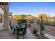 Outdoor patio features desert landscaping, stunning mountain views, and a comfortable seating area at 34423 N 68Th Way, Scottsdale, AZ 85266