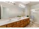 This bathroom features a large mirror, double sinks, and a glass shower at 34423 N 68Th Way, Scottsdale, AZ 85266