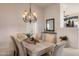 Elegant dining room with rustic wood table, upholstered chairs and decorative lighting at 34423 N 68Th Way, Scottsdale, AZ 85266