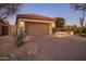 Well-lit garage with a desert landscaped yard, and a paved driveway at 34423 N 68Th Way, Scottsdale, AZ 85266