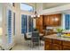 This sun-lit kitchen nook offers wood cabinets, granite countertops, and plantation shutters for a delightful dining experience at 34423 N 68Th Way, Scottsdale, AZ 85266