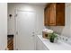 This laundry room includes wooden cabinets, a washing machine, and a dryer at 34423 N 68Th Way, Scottsdale, AZ 85266