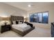 Relax in this main bedroom with a large window offering views to the backyard and an upholstered headboard at 34423 N 68Th Way, Scottsdale, AZ 85266