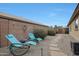 Private backyard featuring two relaxing lounge chairs, desert landscaping, and a tranquil atmosphere at 3519 S 185Th Dr, Goodyear, AZ 85338